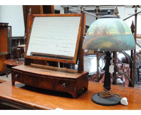 A 1920s table lamp with tapering base and circular foot, with a dome shaped glass shade, painted to the interior with windmil