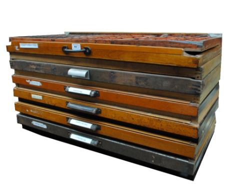 Thirteen vintage wooden fronted drawers, the majority containing small lead printers' blocks, width of drawer front approx 82
