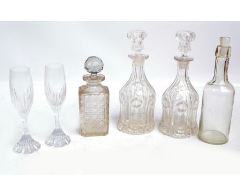 A small collection of glass decanters including a hobnail cut example, a pair of pressed glass decanters (one af), and a bott