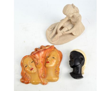 An Art Deco ceramic wall pocket modelled as two female masks flanking a cornucopia, width 23.5cm, unmarked, a further mask wa