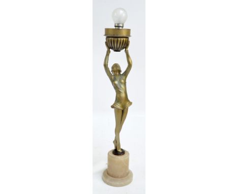 An Art Deco painted spelter figural lamp base modelled as a dancer holding a fluted bowl aloft, on cylindrical alabaster base