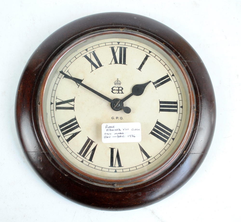 A mahogany GPO circular electric wall clock, the circular dial set with ...