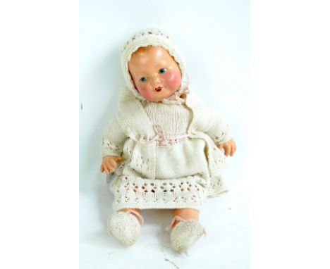 An early 20th century ceramic doll with painted features and hair, with open mouth, height 44cm.