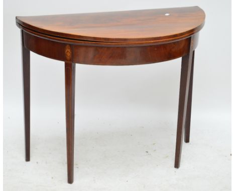 A late George III mahogany and boxwood strung inlaid demi-lune card table raised on square section tapering legs, width 91cm.