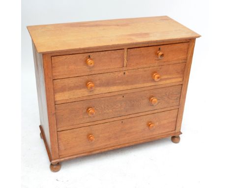 A late 19th century light oak chest of two short and three long drawers raised on bun feet, width 106cm.