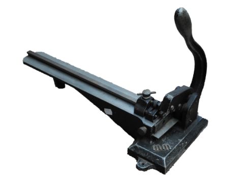 A vintage lead cutter, lino cut and printers' blocks.