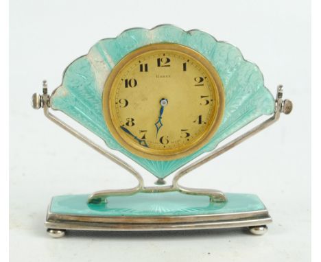 HENRY MATTHEWS; a George V hallmarked silver and pale turquoise guilloche enamel fan shaped eight day desk clock, Birmingham 