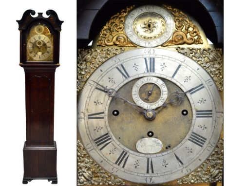 An early 19th century oak longcase clock, the broken swan neck pediment above arched brass dial inscribed 'W.M. Webster, Exch