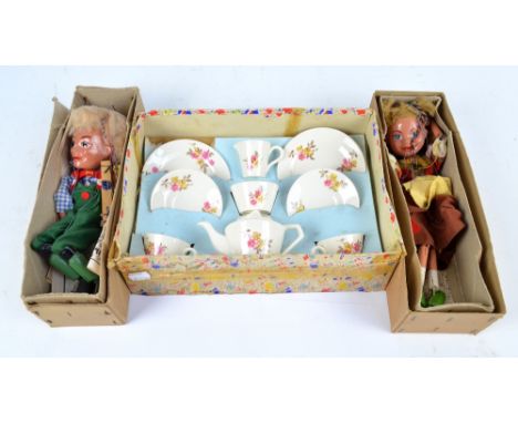 Two boxed Hansel & Gretel Pelham puppets, and a boxed child's ceramic tea set.