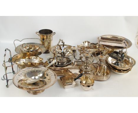 A quantity of electroplated item to include various baskets and dishes, a bottle cooler, a sugar scuttle, a candelabrum, cake