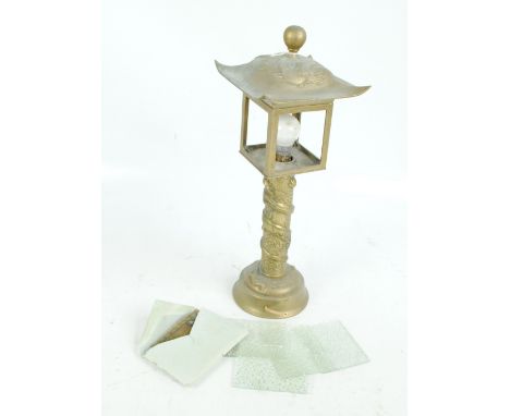 A decorative Oriental style brass table lamp, the four sided lantern with embroidered silk panels.