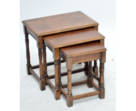 A nest of three oak tables with stretchered supports, a corner cupboard and a pine shelf wall unit (3).