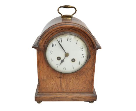 An Edwardian oak and inlaid domed eight days mantel clock, the circular enamel dial set with Arabic numerals, with Japy Frère