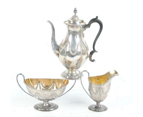 DANIEL & JOHN WELLBY; a late Victorian hallmarked silver three piece tea set, comprising a swag and acanthus decorated balust