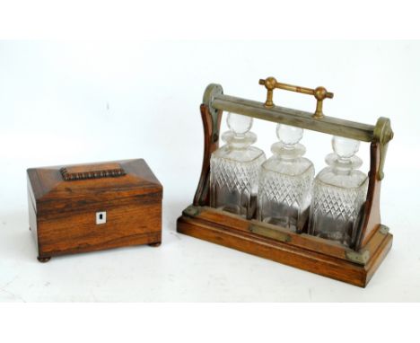 A 19th century rosewood sarcophagus tea caddy with rectangular mother of pearl escutcheon on four turned bun feet (interior a