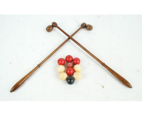 A set of twin ivory and stained ivory game balls, diameter approx 3.5cm, and a pair of mahogany clubs.   CONDITION REPORT:  S