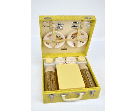A vintage Brexton boxed picnic set comprising a container, two metal flasks, two plastic bottles, four cups and saucers and f