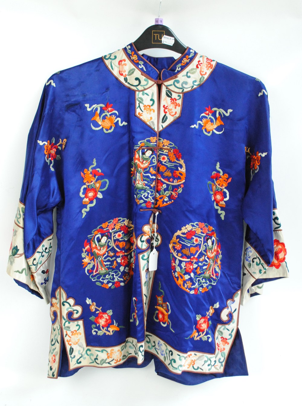 A silk embroidered Chinese jacket with figural, floral and fish ...