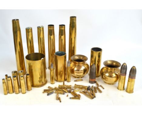 A quantity of brass ammunition shells of various sizes and two brass vases. 