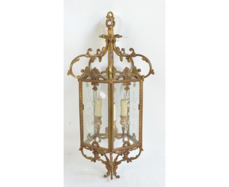 An ornate gilt metal pentagonal pendent hall lantern with five etched glass panels and three lamps fittings, height 63cm.