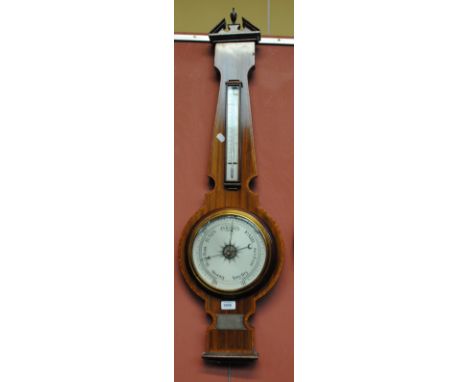 An early 20th century mahogany banjo barometer with crossbanding and inlaid stringing, with urn finial above thermometer and 