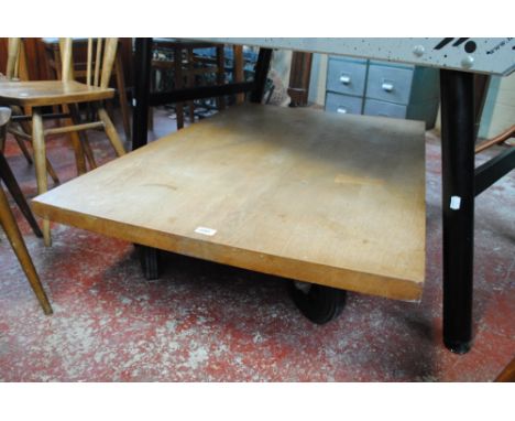 A 'Roller' coffee table with plank top, after a design by Terence Conran.