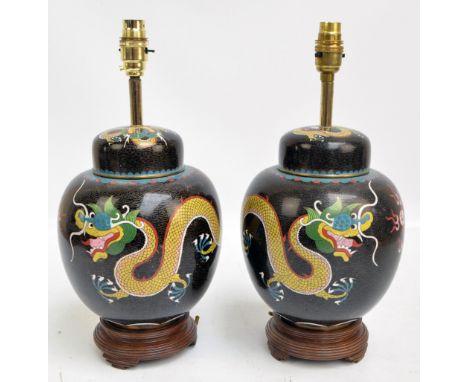 A pair of early 20th century Chinese cloisonné lamp bases converted from ginger jars, decorated with dragons chasing the pear