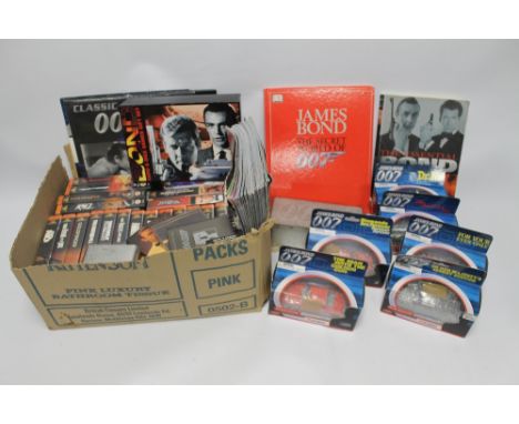 A QUANTITY OF ASSORTED JAMES BOND RELATED ITEMS, to include Playing Cards, Corgi Cars, Calendars etc