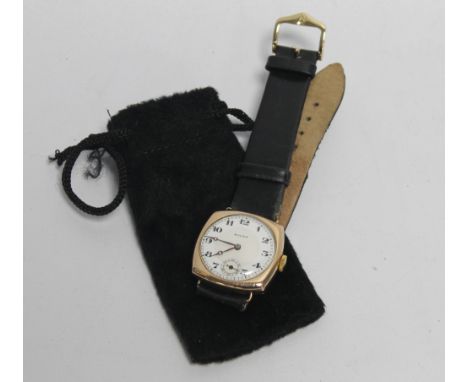 A 9CT GOLD CUSHION VINTAGE ROLEX WRIST WATCH with leather strap, Arabic numerals, subseconds dial, case marked 'R. W. C. Ltd.