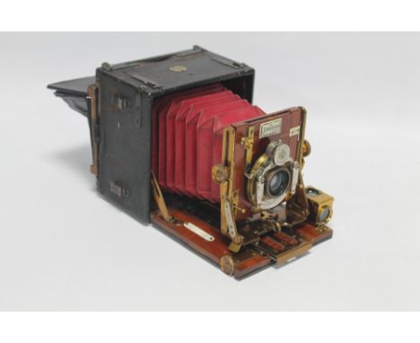 A SANDERSON WOOD AND BRASS ¼ PLATE HAND AND STAND CAMERA