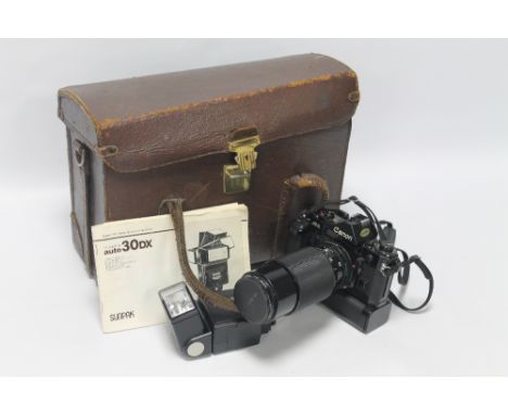 A CANON A-1 35MM SLR FILM CAMERA WITH LENS, FLASH ETC & MANUALS, in brown leather case