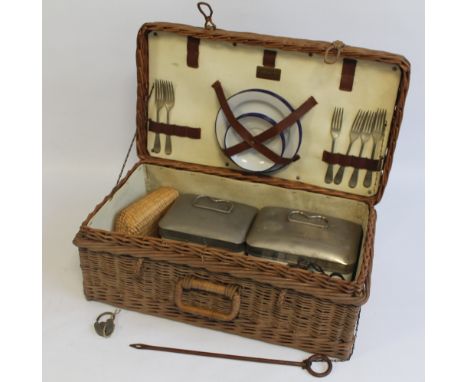 A VINTAGE WICKER PICNIC BASKET, with contents to include enamel cups and saucers, ceramic and metal sandwich boxes etc., comp