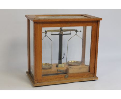 A SET OF BRASS SCIENTIFIC SCALES IN GLASS CASE WITH BOXED WEIGHTS