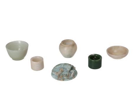Three white jade miniature bowls, two jade archer rings and a jade tossel with a small dragon in relief. China, Qing, the tos
