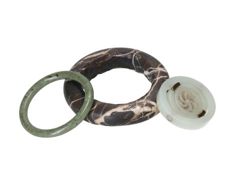 A celadon white jade mounted rotating ring, holding a sculpture of an infinite wheel. Added a green jade bracelet and a dark 