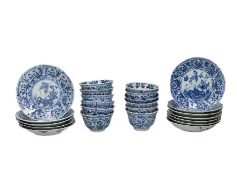 A set of twelve blue and white porcelain cups and saucers, decorated with a landscape and floral decor. Unmarked. China, Kang