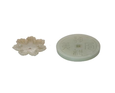 A green jade Bi-disc with carved decor of characters in zhuanshu. Added a white jade flower shaped application. China, possib