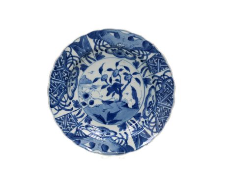 A blue and white 'kraak' porcelain 'klapmuts' bowl with a scalloped rim, decorated with a cricket in a landscape. Unmarked. C