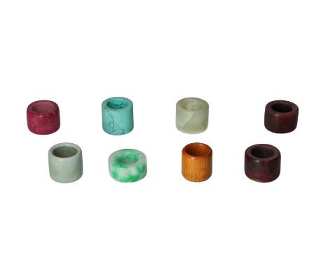 A collection of eight thumb rings of various materials, including soapstone, jade and bone. China, 20th century.Diam. approx.