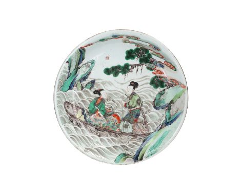 A famille verte porcelain deep saucer, decorated with two women in a boat in a mountainous river landscape. Marked with seal 