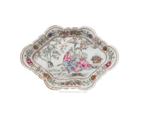 A famille rose porcelain pattipan with scalloped rim, decorated with flowers and Cupid aiming his arrow at a couple in a land