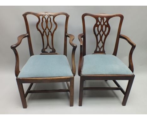 TWO LATE GEORGE III MAHOGANY OPEN ARMCHAIRS, with pierced Chippendale style splats and blue fabric upholstered drop-in seats 