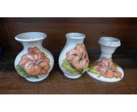 Two small Moorcroft hibiscus vases and a candlestick