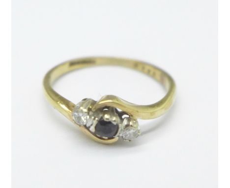 A 9ct gold crossover ring set with a sapphire and diamonds, 1.6g, K