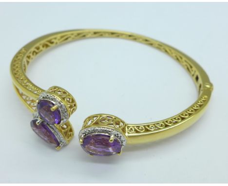 A silver gilt and stone set bangle