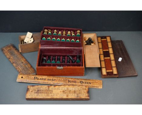 A collection of games to include wooden cribbage boards, chess sets and a dominoes set. 