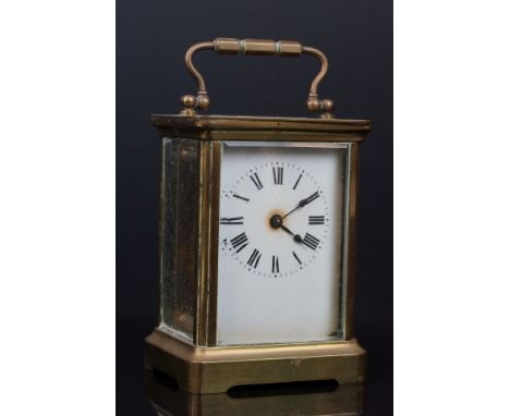 An antique brass cased carriage clock with white enamel dial. 