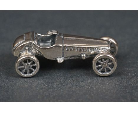 Silver figure of a Morgan car 