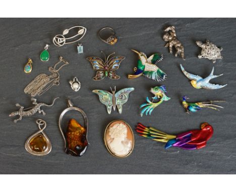 A small collection of costume jewellery brooches and pendants to include silver examples. 