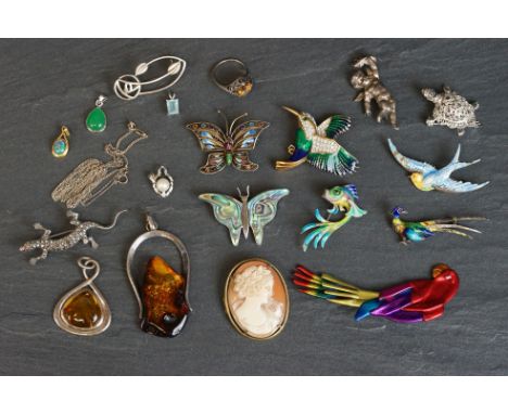 A small collection of costume jewellery brooches and pendants to include silver examples. 